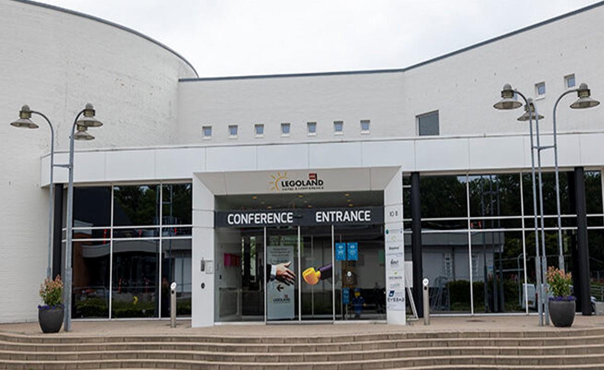 Photo of the UGM host welcoming guests and exhibitors in the auditorium at the User Group Meeting.